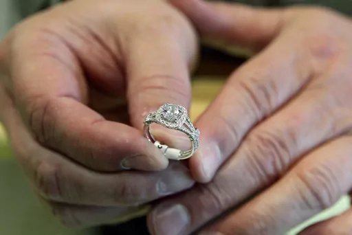 In this May 14, 2014, file photo, Brad Padgett, owner of Bradley's Jewelers, shows off one of his favorite engagement rings in Jacksonville, N.C. There’s a common misconception that prenuptial agreements are only for protecting the assets of an ultra-wealthy person from their spouse, but they can do much more. (Maria Sestito/The Jacksonville Daily News via AP, File)