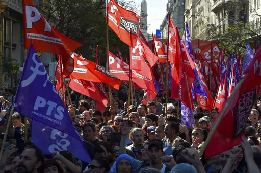 Protesters march against new economic shock measures in Buenos Aires, Argentina, Wednesday, Dec. 20, 2023. Days after taking office, Argentine President Javier Milei's government announced drastic economic measures that angered some social and labor groups, and warned it would crack down on any protests blocking streets. (AP Photo/Gustavo Garello)