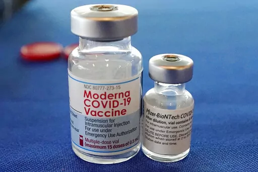 This Sept. 21, 2021 file photo shows vials of the Pfizer and Moderna COVID-19 vaccines in Jackson, Miss. Moderna is suing its main competitors Pfizer and the German drugmaker BioNTech, accusing the rivals of copying Moderna’s technology in order to make their own vaccine. Moderna said Friday, Aug. 26, 2022, that Pfizer and BioNTech’s vaccine Comirnaty infringes on patents Moderna filed several years ago protecting the technology behind its preventive shot, Spikevax.  (AP Photo/Rogelio V. Sol