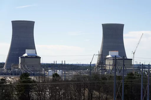 Units 3, left, and 4 and their cooling towers stand at Georgia Power Co.'s Plant Vogtle nuclear power plant, Jan. 20, 2023, in Waynesboro, Ga. Georgia's Public Service Commission voted 5-0 on Tuesday, Dec. 19, 2023 to approve a 6% rate increase for remaining costs that will take effect once Unit 4 begins commercial operation. (AP Photo/John Bazemore, File)