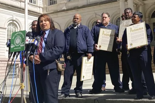 New York City subway train conductor Raven Haynes, who was responsible for making passenger announcements and monitoring the boarding and alighting of the train, during the recent subway attack, speaks at New York City Hall, Friday, April 15, 2022. Haynes and fellow transit workers were honored by Mayor Eric Adams for their response to Tuesday's shooting. (AP Photo/Michelle Price)