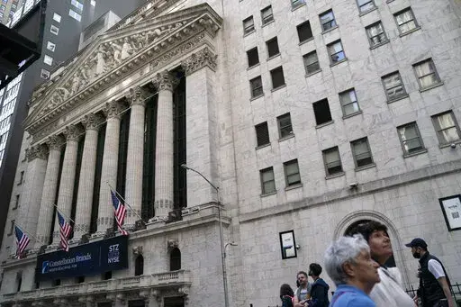 Pedestrians pass the New York Stock Exchange, May 5, 2022, in the Manhattan borough of New York. Stocks are off to a higher start on Wall Street Monday, June 6, 2022 led by more gains in big tech companies. The S&P 500 was up 0.8%. The benchmark index is coming off its eighth losing week in the last nine. The Nasdaq rose 1.2% and the Dow rose 0.5%. (AP Photo/John Minchillo, file)