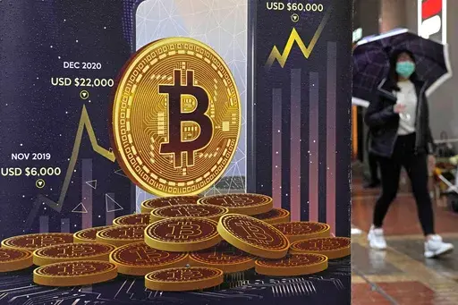An advertisement for Bitcoin cryptocurrency is displayed on a street in Hong Kong, on Feb. 17, 2022. Bitcoin briefly hit an all-time high Tuesday, March 5, 2024, with the world's largest cryptocurrency surpassing $68,800, according to CoinMarketCap. (AP Photo/Kin Cheung, File)