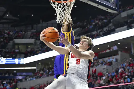 Mississippi guard Eduardo Klafke (8) is fouled by LSU guard Cam Carter, top, during the first half of an NCAA college basketball game in Oxford, Miss., Saturday, Jan. 11, 2025. (AP Photo/Bruce Newman)