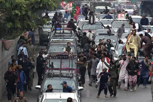 A convey of former Prime Minister Imran Khan drive toward Islamabad at a road in Lahore, Pakistan, Saturday, March 18, 2023. A top Pakistani court on Friday suspended an arrest warrant for Khan, giving him a reprieve to travel to Islamabad and face charges in a graft case without being detained. (AP Photo/K.M. Chaudary)