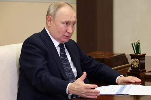 Russian President Vladimir Putin gestures while speaking to the Governor of the Nizhny Novgorod Region, Gleb Nikitin, during their meeting at the Novo-Ogaryovo residence outside Moscow, Russia, Wednesday, May 3, 2023. (Mikhail Klimentyev, Sputnik, Kremlin Pool Photo via AP)