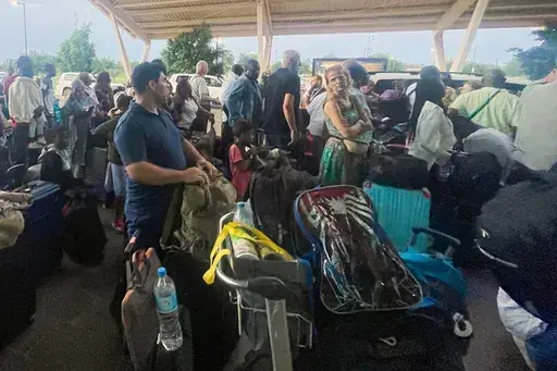 French and other nationals gather at the international Airport to be airlifted back to France on a French military aircraft, in Niamey, Niger, Wednesday, Aug. 2, 2023, to be airlifted back to France on a French military aircraft. French forces in the capital, Niamey, evacuated hundreds of mostly French nationals to Paris on two flights Tuesday, following concerns that their citizens and other Europeans risked becoming trapped by last week’s military coup, which ousted and detained President Mo