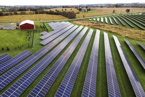 Farmland is seen with solar panels from Cypress Creek Renewables, Oct. 28, 2021, in Thurmont, Md. President Joe Biden plans to invoke the Defense Production Act to increase U.S. manufacturing of solar panels while declaring a two-year tariff exemption on panels from Southeast Asia. (AP Photo/Julio Cortez, File)