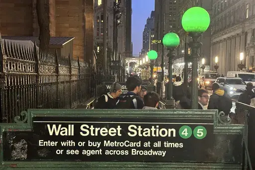Commuters emerge from a Wall Street subway station in New York's Financial District on Wednesday, Oct. 30, 2024. (AP Photo/Peter Morgan)