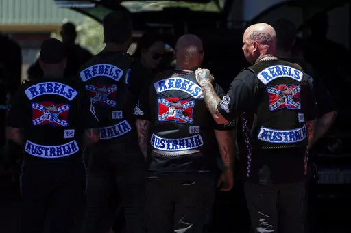 Mourners gather at a funeral parlor in north Perth, Australia before riding to the funeral of murdered Rebels biker Nick Martin at Pinnaroo Cemetery in Perth, Australia, on Wednesday, Dec. 23, 2020. The former Rebels president was gunned down earlier in the month at the Perth Motorplex. Martin’s murder left police a trove of evidence that led them to the culprit. But they wanted more. The coronavirus pandemic provided it in the form of an electronic dragnet: QR code check-in data from contact 