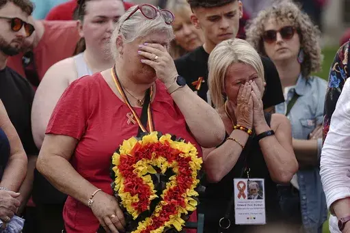 Infected blood campaigners react as they gather in Parliament Square, ahead of the publication of the final report into the scandal, in London, Sunday, May 19, 2024. The final report of the U.K.’s infected blood inquiry will be published Monday, six years after it started its work. The inquiry heard evidence as to how thousands of people contracted HIV or hepatitis from transfusions of tainted blood and blood products in the 1970s and 1980s. (Aaron Chown/PA via AP)