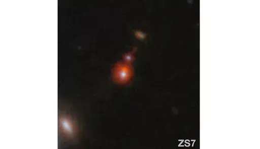 This image released by NASA shows the ZS7 galaxy system, revealing the ionized hydrogen emission in orange and the doubly ionized oxygen emission in dark red. (ESA/Webb, NASA via AP)