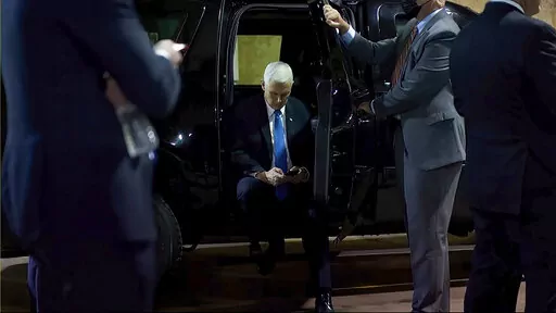 In this image from video released by the House Select Committee, Vice President Mike Pence looks at a phone from his secure evacuation location on Jan. 6 that is displayed as House select committee investigating the Jan. 6 attack on the U.S. Capitol holds a hearing Thursday, June 16, 2022, on Capitol Hill in Washington. (House Select Committee via AP)
