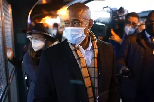 New York City Mayor Eric Adams looks at a fight on the street while waiting for the subway to City Hall on his first day in office in New York, Saturday, Jan. 1, 2022. Adams called the police to report an assault in progress. (AP Photo/Seth Wenig)
