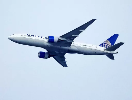 A United Airlines jetliner soars past an MLS soccer match July 8, 2023, in Commerce City, Colo. United Airlines and the union representing its pilots said Saturday, July 15, 2023, they reached agreement on a contract that will raise pilot pay by up to 40% over four years. (AP Photo/David Zalubowski, File)