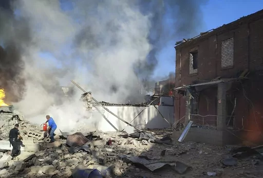 In this photo provided by the Ukrainian Emergency Service, people work to extinguish a fire following a Russian attack in Kryvyi Rih, Ukraine, Friday, Sept. 8, 2023. (Ukrainian Emergency Service via AP)