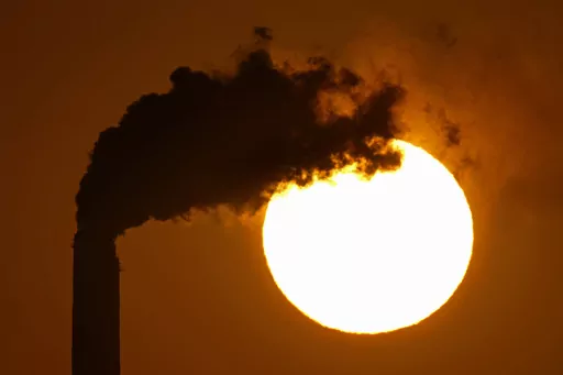 Emissions rise from the smokestacks at the Jeffrey Energy Center coal power plant as the suns sets Sept. 18, 2021, near Emmett, Kan. The Biden administration is setting tougher standards for deadly soot pollution, saying that reducing fine particle matter from tailpipes, smokestacks and other industrial sources could prevent thousands of premature deaths a year. (AP Photo/Charlie Riedel, File)