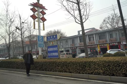 A man walks along the road in the city of Handan in northern China's Hebei province on Feb. 28, 2024. Chinese authorities in the Feixiang district near Handan city announced three suspects have been detained over the March 10, 2024 gruesome murder of a thirteen-year-old boy, riveting users on Chinese social media and sparking debate over bullying and mental health in China's countryside. (AP Photo/Emily Wang Fujiyama, File)
