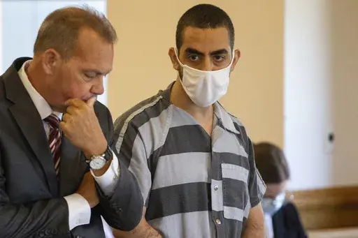Defense attorney Nathaniel Barone, left, and Hadi Matar, 24, right, listen during an arraignment in the Chautauqua County Courthouse in Mayville, NY., Thursday, Aug. 18, 2022. Matar, who severely injured author Salman Rushdie in a frenzied knife attack in western New York faces a new charge that he supported a terrorist group. An indictment unsealed in U.S. District Court in Buffalo on Wednesday, July 24, 2024, charges Matar with providing material support to Hezbollah, a militant group based in