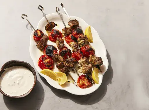 This image released by Milk Street shows a recipe for souvlaki-inspired pork skewers (Milk Street via AP)