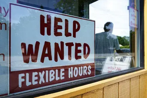 Help wanted sign is displayed in Deerfield, Ill., Wednesday, Sept. 21, 2022.  The number of available jobs in the U.S. plummeted in August compared with July, a sign that businesses may pull back further on hiring and potentially cool chronically high inflation.  There were 10.1 million advertised jobs on the last day of August, the government said Tuesday, Sept. 4, down a huge 10% from 11.2 million openings in July. In March, job openings had hit a record of nearly 11.9 million.  (AP Photo/Nam 