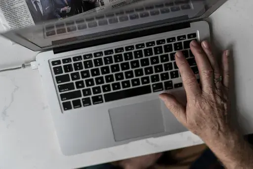 A person works on a laptop computer in Hudson, Wis., Nov. 16, 2022. (AP Photo/David Goldman, File)