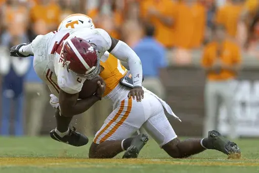 Alabama quarterback Jalen Milroe (4) is tackled by Tennessee defensive back Andre Turrentine (2) during the second half of an NCAA college football game Saturday, Oct. 19, 2024, in Knoxville, Tenn. (AP Photo/Wade Payne)