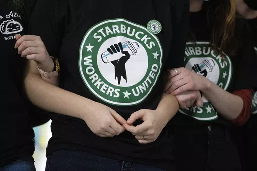 Starbucks employees and supporters link arms during a union election watch party Dec. 9, 2021, in Buffalo, N.Y. The U.S. Supreme Court is set to hear oral arguments in a case filed by Starbucks against the National Labor Relations Board. (AP Photo/Joshua Bessex, File)