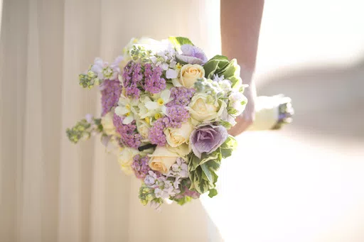 A bride holds a bouquet during her wedding in Ein Hemed, Israel on Dec. 14, 2017. The Marriage Pact is an annual matching ritual that has become a popular staple on nearly 90 college campuses around the country. About 500,000 students have done the pact since it first rolled out at Stanford University in 2017. (AP Photo/Ariel Schalit, File)