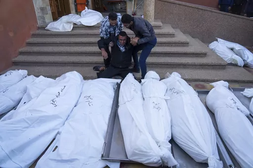 Palestinians mourn their relatives killed in the Israeli bombardment of the Gaza Strip, in the hospital in Khan Younis, Sunday, Dec. 3, 2023. (AP Photo/Fatima Shbair)