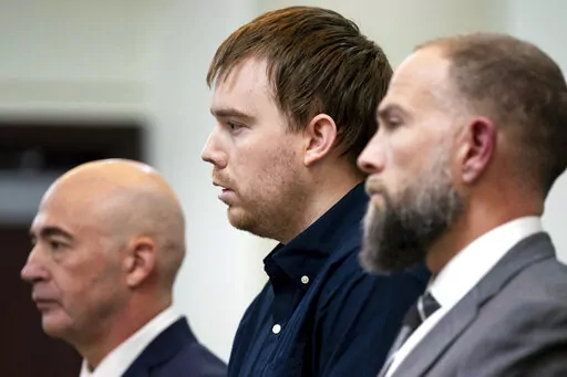Travis Reinking, center, reacts as the verdict is read during day five of Reinking's murder trial at the Justice A.A. Birch Building in Nashville, Tenn., Friday, Feb. 4, 2022. A jury found Reinking guilty of first-degree murder in the deaths of four people at a Waffle House in 2018. (Andrew Nelles/The Tennessean via AP, Pool)