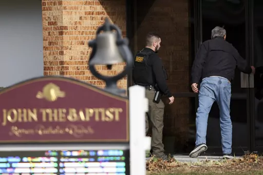 The Washington County Sheriff's office investigates the scene of a fatal stabbing on a Catholic priest in the rectory of St. John the Baptist Church, Sunday, Dec. 10, 2023, in Fort Calhoun, Neb. The Rev. Stephen Gutgsell died at an Nebraska hospital, according to a statement from the Archdiocese of Omaha. Police say a person is in custody. (Nikos Frazier/Omaha World-Herald via AP)