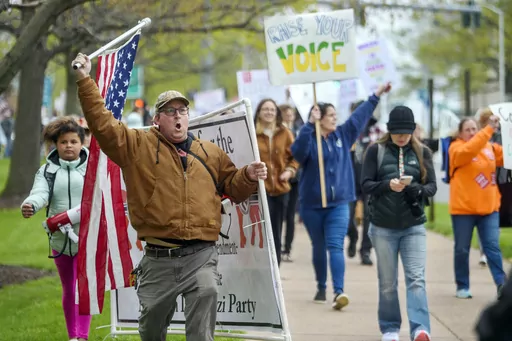 Opponents of a bill to repeal Connecticut's religious exemption for required school vaccinations march down Capitol Avenue before the State Senate voted on legislation on April 27, 2021, in Hartford, Conn. Connecticut eliminated its longstanding religious waiver for vaccinations in 2021, joining California, West Virginia, New York and Maine in allowing only medical exemptions. (Mark Mirko/Hartford Courant via AP, File)