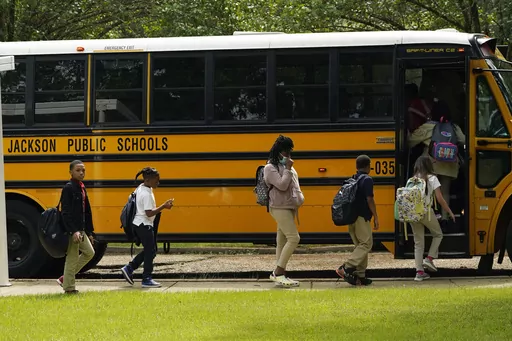 Spann Elementary School students board a school bus following a full day of in-school learning, Sept. 6, 2022, in Jackson, Miss. After the COVID-19 pandemic disrupted schools around the country and led to more children missing classes, the number of students who were chronically absent in Mississippi declined during the most recent school year, according to data released, Tuesday, Sept. 26, 2023, by the state's education department. (AP Photo/Rogelio V. Solis, File)