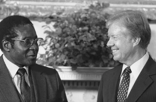 President Jimmy Carter meets with Zimbabwe Prime Minister Robert Mugabe in the Oval Office in Washington, on Aug. 27, 1980. (AP Photo/Barry Thumma, File)