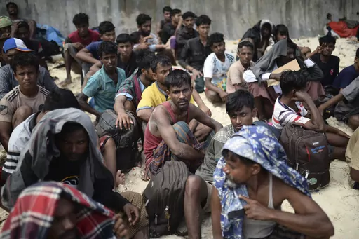 Ethnic Rohingya men sit on a beach after they landed in Sabang, Aceh province, Indonesia, Wednesday, Nov. 22, 2023. The U.N. refugee agency on Monday Dec. 4, 2023 sounded the alarm for hundreds of Rohingya Muslims believed to be aboard two boats reported to be out of supplies and adrift on the Andaman Sea. (AP Photo/Reza Saifullah, File)