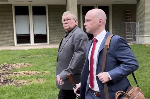 The former head of a Michigan marijuana licensing board Rick Johnson, left, walks with his attorney Nick Dondzila, outside federal court, Tuesday, April 25, 2023, in Grand Rapids, Mich. Johnson pleaded guilty to bribery, acknowledging he accepted at least $110,000 in exchange for approving applications for the lucrative business. Johnson's appearance in federal court was a remarkable fall. Years ago he was a powerful state lawmaker, serving as speaker of the Republican-controlled House from 2001