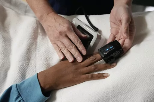 A nurse checks the vitals of a 33-year-old woman in Shreveport, La., on Oct. 9, 2021. A survey by KFF, a health policy research group, released Tuesday, Dec. 5, 2023, shows 60% of Black patients said they prepare for insults or feel they have to be careful about their appearance in order to be treated fairly by health providers. (AP Photo/Rebecca Blackwell, File)