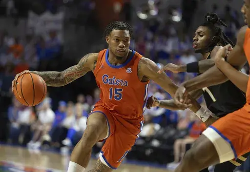 Florida guard Alijah Martin (15) drives against Vanderbilt guard Jason Edwards (1) during the second half of an NCAA college basketball game Tuesday, Feb. 4, 2025, in Gainesville, Fla. (AP Photo/Alan Youngblood)