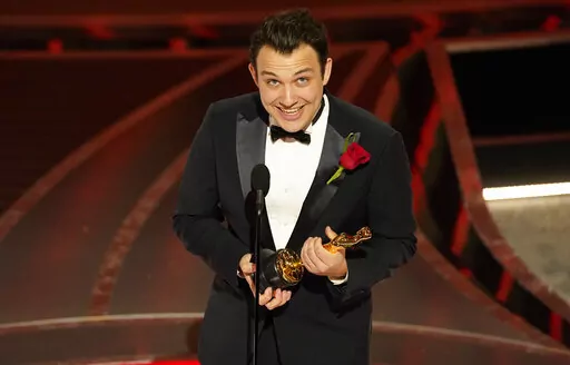 Ben Proudfoot accepts the award for best documentary short subject for "The Queen of Basketball" at the Oscars on Sunday, March 27, 2022, at the Dolby Theatre in Los Angeles. (AP Photo/Chris Pizzello)