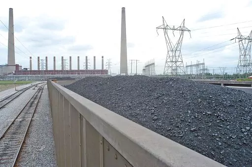 Coal is shown inside one of the train cars headed for the dumping area of the Shawnee Fossil Plant in western McCracken County, Ky. The nation's largest public utility has proposed building a $216 million solar farm project in Kentucky atop a capped coal ash storage pit at one of its coal-fired power plants. The federal Tennessee Valley Authority voted Thursday, Nov. 10, 2022 to advance the initiative at Shawnee Fossil Plant in Paducah. (John Wright/The Paducah Sun via AP)