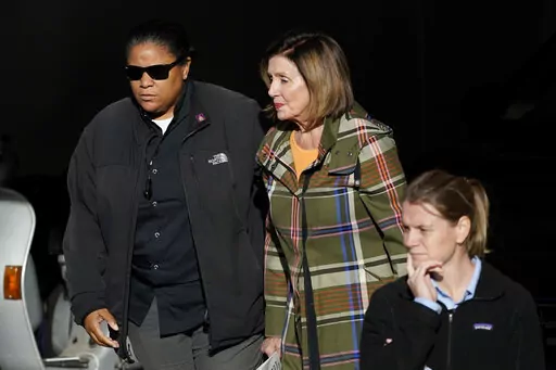 House Speaker Nancy Pelosi, middle, is escorted to a vehicle outside of her and husband Paul Pelosi's home in San Francisco, Wednesday, Nov. 2, 2022. (AP Photo/Jeff Chiu)