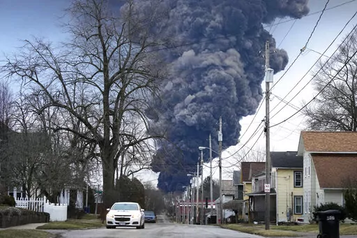 A black plume rises over East Palestine, Ohio, as a result of a controlled detonation of a portion of the derailed Norfolk Southern trains, on Feb. 6, 2023. Transportation Secretary Pete Buttigieg announced a package of reforms to improve safety Tuesday, Feb. 21 — two days after he warned the railroad responsible for the derailment, Norfolk Southern, to fulfill its promises to clean up the mess just outside East Palestine, and help the town recover. (AP Photo/Gene J. Puskar, File)
