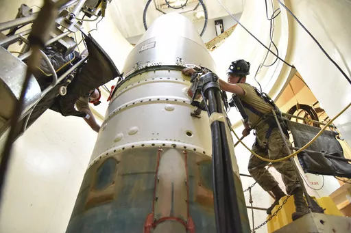 In this image provided by the U.S. Air Force, Airman 1st Class Jackson Ligon, left, and Senior Airman Jonathan Marinaccio, 341st Missile Maintenance Squadron technicians, connect a re-entry system to a spacer on an intercontinental ballistic missile during a Simulated Electronic Launch-Minuteman test Sept. 22, 2020, at a launch facility near Malmstrom Air Force Base in Great Falls, Mont. The Air Force says a review of a Montana nuclear missile base where an unusual number of troops have reported
