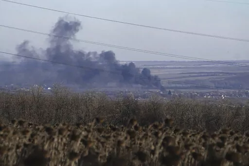 Smoke billows during fighting between Ukrainian and Russian forces in Soledar, Donetsk region, Ukraine, Wednesday, Jan. 11, 2023. Soledar and Bakhmut again highlighted a bitter rift between the top military brass and Yevgeny Prigozhin, a rogue millionaire whose Wagner Group military contractor has played an increasing role in Ukraine. (AP Photo/Libkos, File)