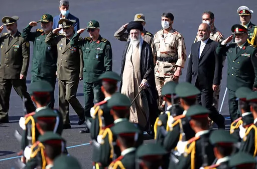 In this picture released by the official website of the office of the Iranian supreme leader, Supreme Leader Ayatollah Ali Khamenei, center, reviews a group of armed forces cadets during their graduation ceremony accompanied by commanders of the armed forces, at the police academy in Tehran, Iran, Monday, Oct. 3, 2022. Khamenei responded publicly on Monday to the biggest protests in Iran in years, breaking weeks of silence to condemn what he called “rioting” and accuse the U.S. and Israel of