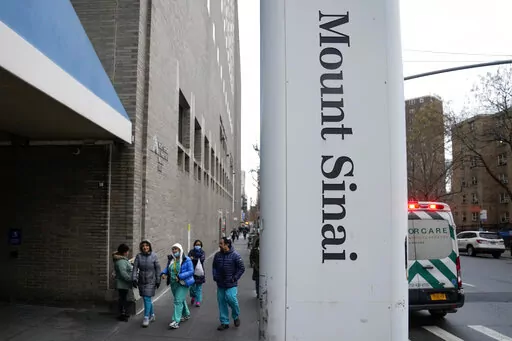 People enter Mount Sinai Hospital in New York, Thursday, Jan. 12, 2023. Two New York City hospitals have reached a tentative contract agreement with thousands of striking nurses that ends the walkout, the nurses' union announced today. (AP Photo/Seth Wenig)