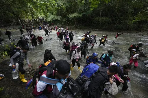 Migrants cross a river during their journey through the Darien Gap from Colombia into Panama, hoping to reach the U.S., Oct. 15, 2022. President-elect José Raúl Mulino said Thursday, May 9, 2024, he will shut down the migration route used by more than 500,000 people last year. Until now, Panama has helped speedily bus the migrants across its territory so they can continue their journey north. (AP Photo/Fernando Vergara, File)