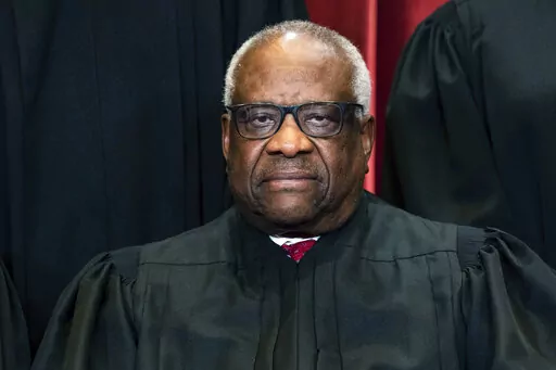 Justice Clarence Thomas sits during a group photo at the Supreme Court in Washington, on Friday, April 23, 2021. Thomas has been hospitalized because of an infection, the Supreme Court said Sunday, March 20, 2022. Thomas, 73, has been at Sibley Memorial Hospital in Washington, D.C., since Friday, March 18 after experiencing “flu-like symptoms,” the court said in a statement. (Erin Schaff/The New York Times via AP, Pool, File)