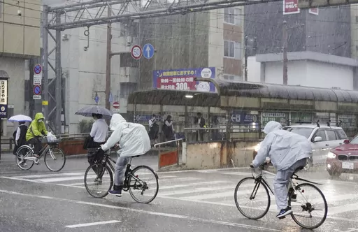 People make their way in a strong rain in Kochi, southern Japan Friday, June 2, 2023. A weakened Tropical Storm Mawar brought heavy rains to Japan’s main southern islands Friday after passing the Okinawan archipelago and causing injuries to several people. (Kyodo News via AP)